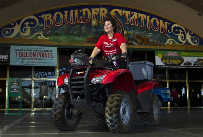 Boulder Station employee Pat Hadlett atop her ATV which she loves to ride when not a guest services ambassador for slots on Friday, August 15, 2014.  She is pleased to be helping the casino in celebrating its 20th year anniversary.