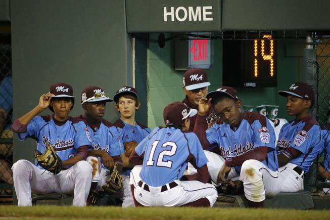 Philadelphia players wait on the dugout steps to the take the field for the sixth inning of a United States semi-final baseball game against Las Vegas at the Little League World Series tournament in South Williamsport, Pa., Wednesday, Aug. 20, 2014. Las Vegas won 8-1. (AP Photo/Gene J. Puskar)