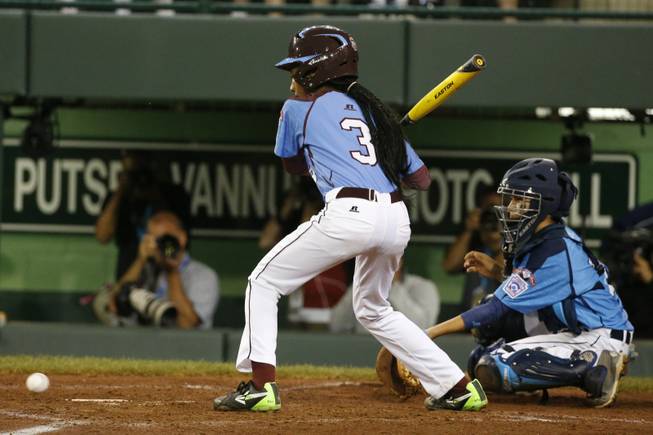 Philadelphia's Mo'ne Davis watches as a 3-2 pitch by Las Vegas pitcher Brad Stone bounces past the catcher allowing Davis to get on base and Philadelphia's only run of the game to score in the fourth inning of a United States semi-final baseball game at the Little League World Series tournament in South Williamsport, Pa., Wednesday, Aug. 20, 2014. Las Vegas won 8-1. (AP Photo/Gene J. Puskar)