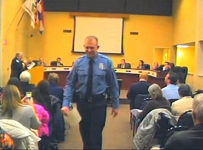 In this Feb. 11, 2014, image from video released by the City of Ferguson, Mo., officer Darren Wilson attends a city council meeting in Ferguson. Police identified Wilson, 28, as the police officer who shot Michael Brown on Aug. 9, 2014, sparking over a week of protests in the suburban St. Louis town. 
