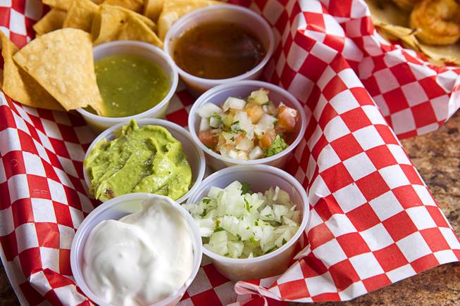 Toppings are shown for a Taco Trio (shrimp, carne asada and adobada tacos) at Saborr, a Mexican fast food restaurant at 4348 E. Craig Rd., Thursday, Aug. 21, 2014.