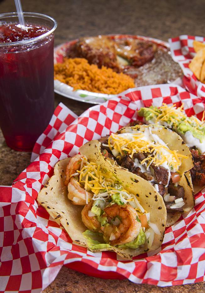 A Taco Trio (shrimp, carne asada and adobada tacos before toppings) with rice and refried beans, and Chile Relleno (back left) at Saborr, a Mexican fast food restaurant at 4348 E. Craig Rd., Thursday, Aug. 21, 2014. The drink is a Hibiscus flower tea.