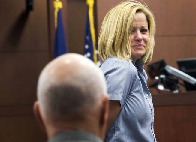 Dea Millerberg, convicted of helping her husband dump their teenage baby sitter's body in the woods after a night of sex and drugs, glances back at her family as she is escorted out of the court after her sentencing hearing Thursday, Aug. 21, 2014, in Ogden, Utah. Millerberg, who pleaded guilty in June to three felonies, including desecration of a human body, was sentenced to prison for up to five years.