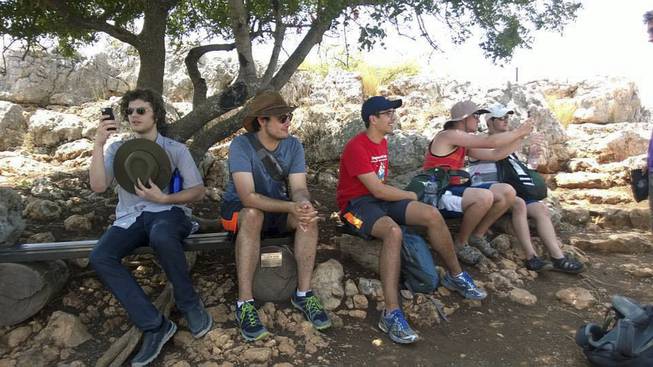In this 2014 photo provided by Michigan State University, students in the school's Summer Study Abroad Program take a break while hiking in Israel. Some U.S. colleges have now pulled students from their overseas study programs in Israel as the Gaza war rages. Colleges site security as the top concern.
