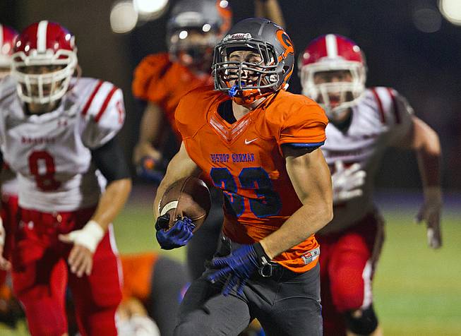 Bishop Gorman's Jonathan Shumaker (33) breaks free for a long touchdown run against Brophy Prep on Friday, Aug. 22, 2014.