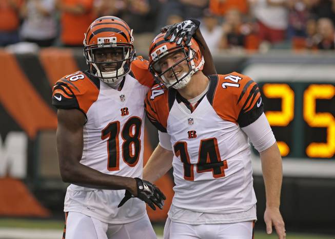 Cincinnati Bengals wide receiver A.J. Green (18) and quarterback Andy Dalton (14) celebrate after the Bengals scored against the New York Jets in the first half of an NFL preseason football game, Saturday, Aug. 16, 2014, in Cincinnati.