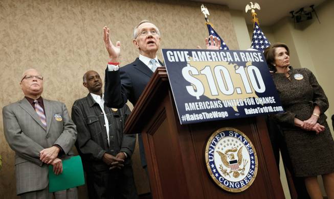 Senate Majority Leader Harry Reid, D-Nev., speaks during an April event to urge raising the minimum wage. Featured on the lectern are both a Twitter hashtag and website. The hashtag has become ubiquitous in American politics since the advent of Twitter.