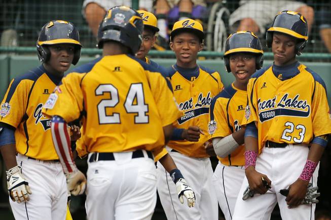 Chicago's Trey Hondras (24) is greeted by teammates after hitting a two-run home run off Las Vegas' Brennan Holligan in the first inning of a United States Championship game at the Little League World Series tournament in South Williamsport, Pa., Saturday, Aug. 23, 2014.