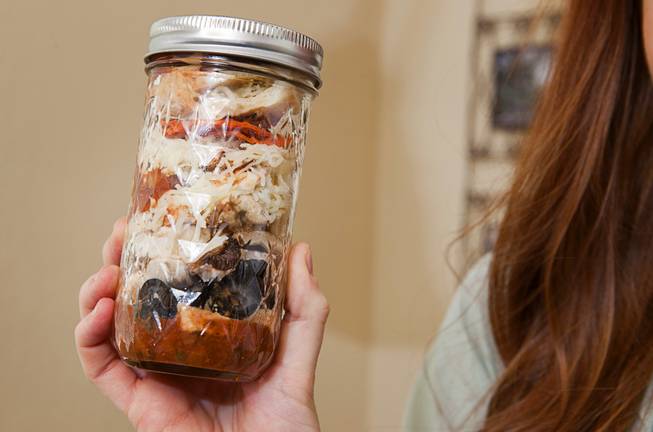Chelsea Meggerson holds "pizza in a jar" in her kitchen Sunday, Aug. 24, 2014. Meggerson, a UNLV student, provides a service where she provides families with fresh meals in Mason jars. She shares her recipes on her website theinspiregreen.com.