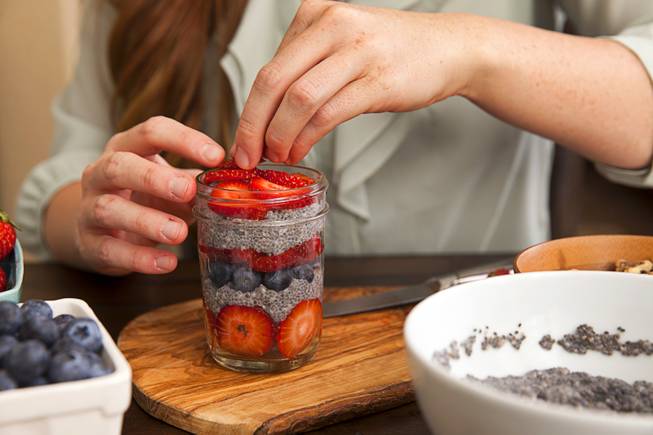 Chelsea Meggerson prepares a chia seed parfait in a  Mason jar in her apartment Sunday, Aug. 24, 2014. Meggerson, a UNLV student, provides a service where she provides families with fresh meals in Mason jars. The parfait uses raw chia seeds mixed with homemade almond milk, fresh fruit, hemp hearts, walnuts and pecans.