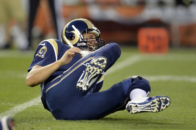 St. Louis Rams quarterback Sam Bradford grimaces after being hit by Cleveland Browns defensive lineman Armonty Bryant in the first quarter of a preseason NFL football game Saturday, Aug. 23, 2014, in Cleveland.
