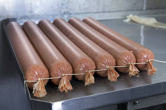 Venison sausage is shown in a cutting room at John Mull's Meats and Road Kill Grill, 3730 Thom Blvd., Monday, Aug. 25, 2014.