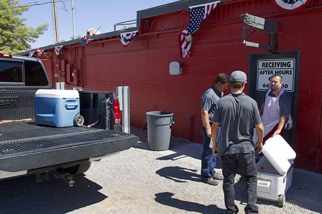 Hunter drop off game meat for processing at John Mull's Meats and Road Kill Grill, 3730 Thom Blvd., Monday, Aug. 25, 2014.