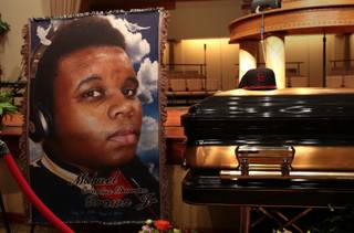 The casket of Michael Brown sits inside Friendly Temple Missionary Baptist Church awaiting the start of his funeral on Monday, Aug. 25, 2014. Brown, who is black, was unarmed when he was shot Aug. 9 in Ferguson, Mo., by Officer Darren Wilson, who is white. 