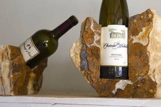 Stone wine holders are displayed at Larry Turner's Native Wine Rocks workshop Tuesday, August 26, 2014. The business takes natural stone from the Southwest and Pacific Northwest and creates functional art.
