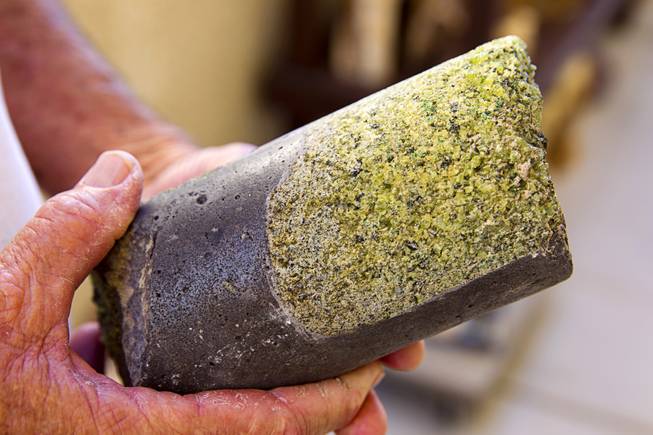 Larry Turner, co-owner of Native Wine Rocks, holds a core containing jade at his workshop Tuesday, August 26, 2014. The business takes natural stone from the Southwest and Pacific Northwest and creates functional art. Cores are made into coasters or business card holders.