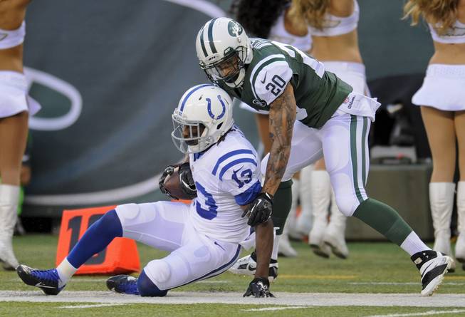 New York Jets cornerback Kyle Wilson (20) pulls Indianapolis Colts wide receiver T.Y. Hilton (13) out of bounds in the first quarter of an NFL football game, Thursday, Aug. 7, 2014, in East Rutherford, N.J.