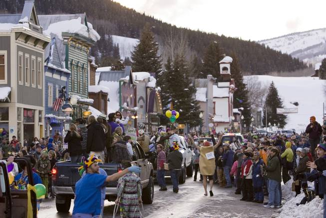 In this Feb. 24, 2009, file photo, a crowd gathers on Elk Avenue in Crested Butte, Colo., during a Mardi Gras parade celebration.