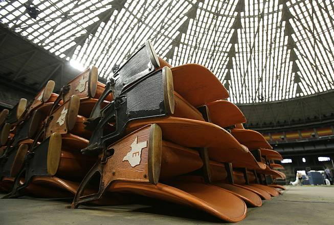 Old Astrodome seats sit in stacks around the unused historic domed stadium Tuesday, Aug. 26, 2014, in Houston. County officials are proposing turning the stadium into the world's largest indoor park. 