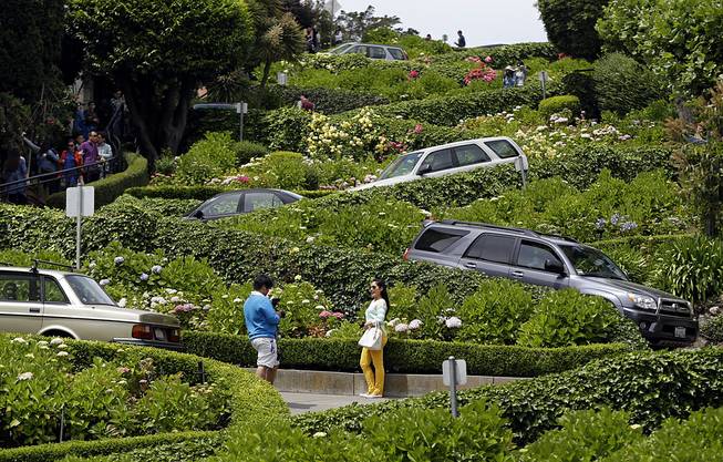 Motorists make their way down Lombard Street on May 20, 2014, in San Francisco. Two Dutch tourists were robbed at gunpoint Tuesday, Aug. 26, 2014, while they were taking pictures there.