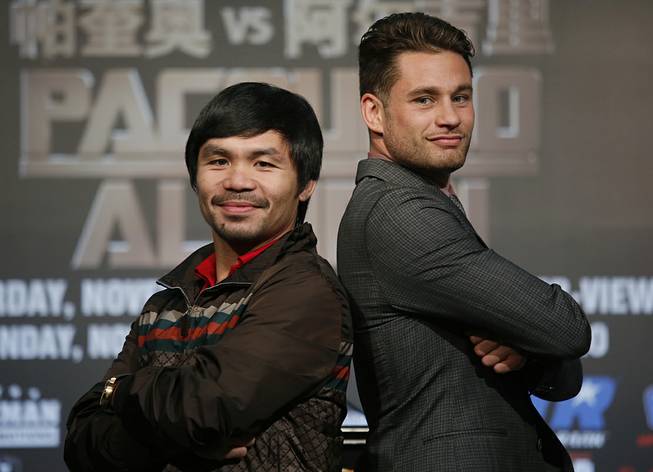 WBO Welterweight champion Manny Pacquiao, left, of the Philippines, and WBO junior welterweight champion Chris Algieri of United States, right, pose for photographers during a news conference in Macau, Monday, Aug. 25, 2014. The boxers are scheduled to battle in WBO welterweight title match at The Venetian Macao on Nov. 23 in Macau. 
