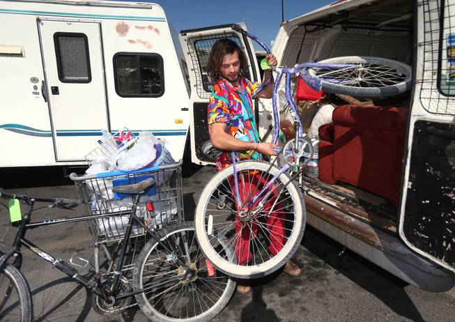 Eddie Southerden, of London, loads supplies, Tuesday, Aug. 26, 2014, at a Wal-Mart in Reno, Nev. Southerden is one of many Burners delayed after a rare rain storm temporarily closed the entrance to Burning Man yesterday causing long traffic backups. The gates reopened at 6 a.m. Tuesday for the weeklong counter-culture festival that draws 70,000 people to the Black Rock Desert. 