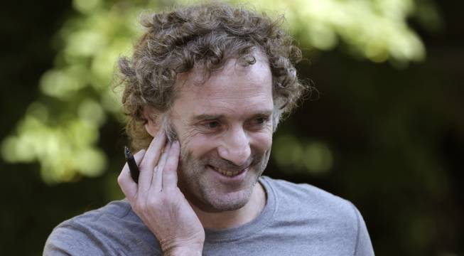 Peter Theo Curtis smiles as he talks with reporters outside his mother's home in Cambridge, Mass., Wednesday, Aug. 27, 2014. Curtis, a freelance reporter who wrote under the byline Theo Padnos and who had been held hostage for about two years in Syria, returned to the U.S. Tuesday.