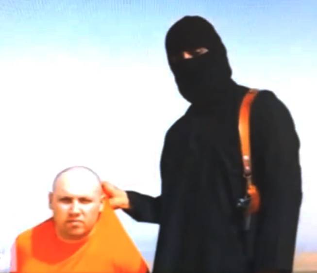 This still image from an undated video released by Islamic State militants on Tuesday, Aug. 19, 2014, purports to show journalist Steven Sotloff being held by the militant group.