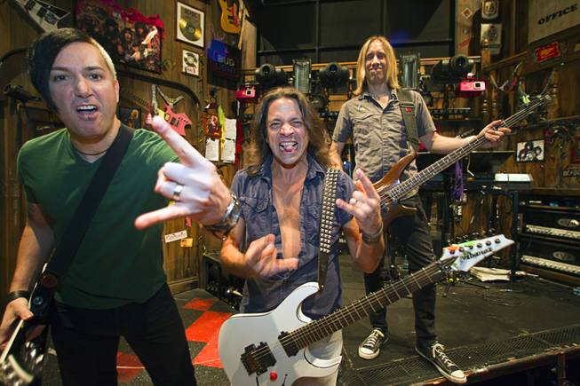 Guitarist Andy Gerold, left, guitarist Chris Cicchino, center, and bassist Dan Grennes strike a pose on stage before a performance of "Rock Of Ages" at the Venetian Wednesday, Aug. 27, 2014.