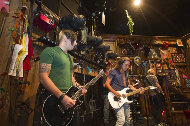 Guitarist Andy Gerold, left, guitarist Chris Cicchino, center, and bassist Dan Grennes test out equipment before a performance of "Rock Of Ages" at the Venetian Wednesday, Aug. 27, 2014.