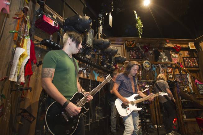 Guitarist Andy Gerold, left, guitarist Chris Cicchino, center, and bassist Dan Grennes test out equipment before a performance of "Rock Of Ages" at the Venetian Wednesday, Aug. 27, 2014. 
