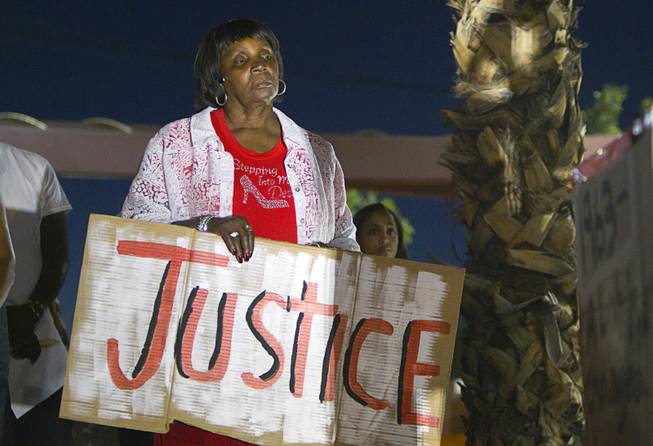 Patricia Polk participates in a vigil for Michael Brown at Martin Luther King Boulevard and Carey Avenue Thursday, August 28, 2014. Brown, 18, was shot and killed by a police officer Aug. 9, 2014 in Ferguson, Mo.