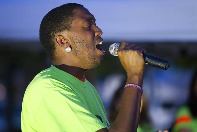Monte J. sings the national anthem during a vigil for Michael Brown at Martin Luther King Boulevard and Carey Avenue Thursday, August 28, 2014. Brown, 18, was shot and killed by a police officer Aug. 9, 2014 in Ferguson, Mo.