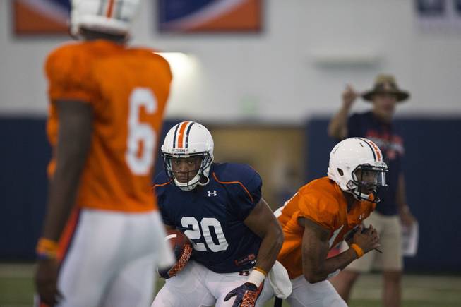 Auburn running back Corey Grant (20) takes a handoff during a drill at an NCAA college football practice Tuesday, Aug. 5, 2014, in Auburn, Ala. 