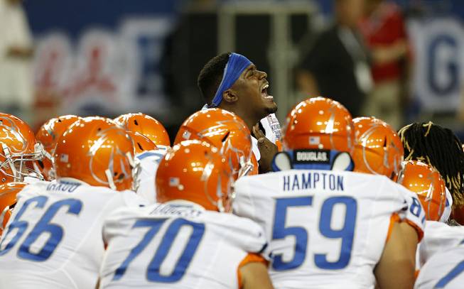 Boise State defensive tackle Armand Nance (40), center, huddles with his teammates before the first half of an NCAA football game against Mississippi, Thursday, Aug. 28, 2014, in Atlanta.