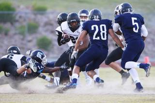Centennial's Zach Mayslooks for an opening in the Palo Verde defense during their game Friday, Aug. 29, 2014 at Centennial.