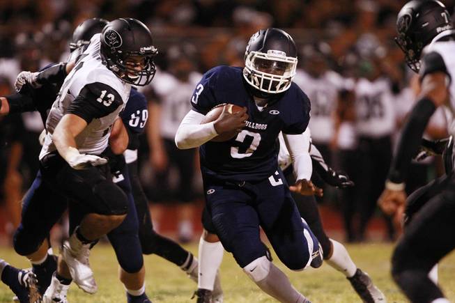 Centennial running back Rhamondre Stevenson finds a hole in the Palo Verde line during their game Friday, Aug. 29, 2014 at Centennial.