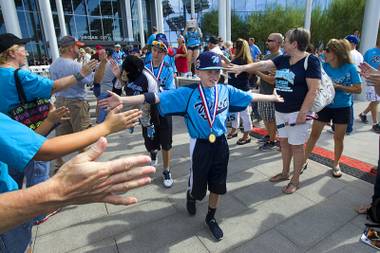 Members of the Mountain Ridge Little League team head to a bus during a ceremony at Las Vegas City Hall Saturday, Aug. 30, 2014. After the ceremony, the team boarded an double-decker, open-air Big Bus for a police-escorted parade down the Las Vegas Strip.