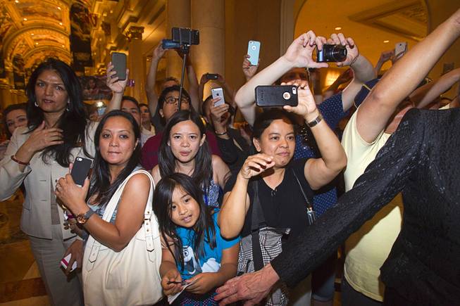 Fans of Filipino boxer Manny Pacquiao try to get his photo as he arrives at the Venetian Saturday, Aug. 30, 2014. Pacquiao and his opponent and Chris Algieri of Huntington, N.Y. are on day six of an international tour promoting their WBO welterweight title fight in Macau, China on November 22, 2014.