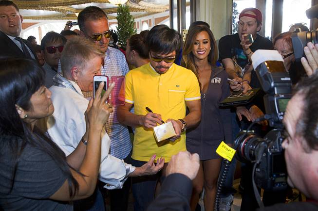 Boxer Manny Pacquiao of the Philippines signs autographs as he arrives at the Venetian Saturday, Aug. 30, 2014. Pacquiao and his opponent Chris Algieri of Huntington, N.Y. are on day six of an international tour promoting their WBO welterweight title fight in Macau, China on November 22, 2014.