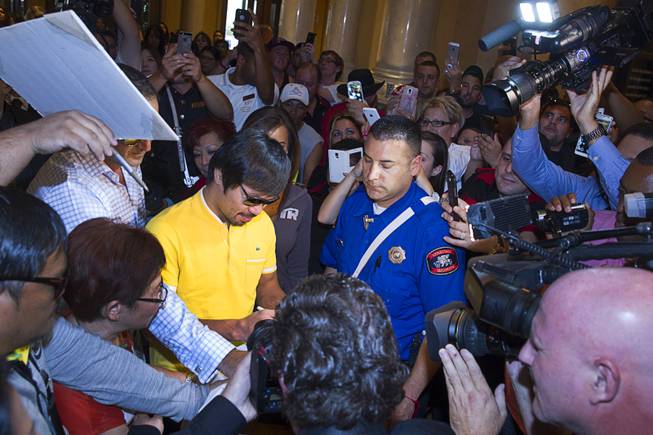 Boxer Manny Pacquiao is surrounded by media and fans as he arrives at the Venetian Saturday, Aug. 30, 2014. Pacquiao and his opponent Chris Algieri of Huntington, N.Y. are on day six of an international tour promoting their WBO welterweight title fight in Macau, China on November 22, 2014.