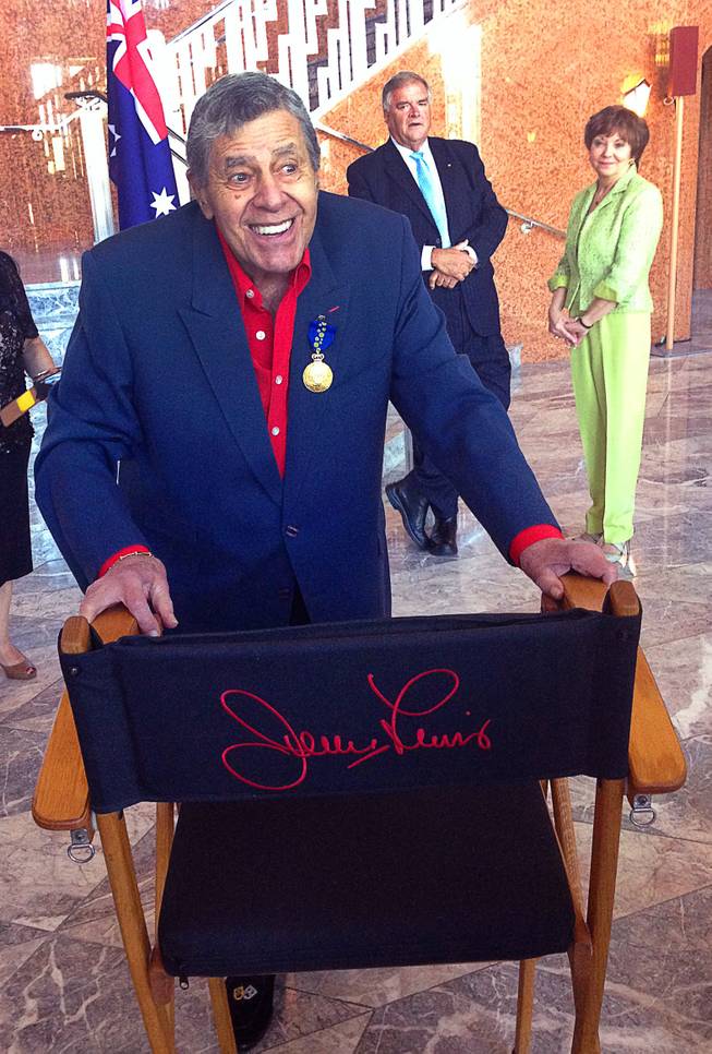 Jerry Lewis mugs behind his famous director's chair at the Smith Center for the Performing Arts on Friday, Aug. 29, 2014, as he is admitted as a Member of the Order of Australia, the highest civilian honor awarded by that country. Lewis was recognized for his work with the Muscular Dystrophy Foundation of Australia.