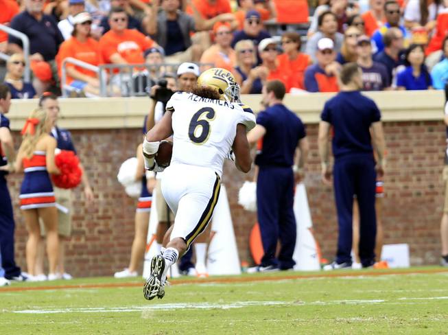 UCLA linebacker Eric Kendricks returns an interception for a touchdown during the first half of an NCAA college football game against Virginia at Scott Stadium, Saturday, Aug. 30, 2014, in Charlottesville, Va. 