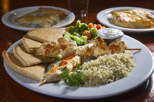 A Souvlaki Plate, foreground, Spanakopita, back left, and Tiropita are displayed at the E&N Family Table Restaurant,4460 S. Durango Dr., Sunday, Aug. 31, 2014.