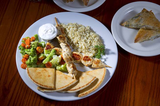 A Souvlaki Plate and Spanakopita are displayed at the E&N Family Table Restaurant, 4460 S. Durango Dr., Sunday, Aug. 31, 2014.