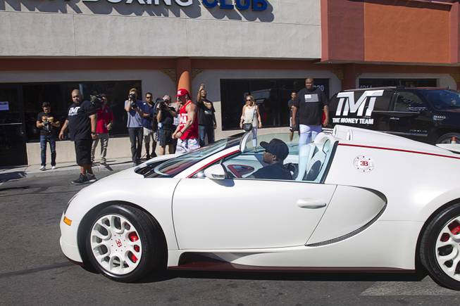 WBC/WBA welterweight champion Floyd Mayweather Jr. arrives in a Bugatti Veyron Grand Sport Vitesse during a media day at the Mayweather Boxing Club Tuesday, Sept. 2, 2014. Mayweather will face Marcos Maidana of Argentina in a rematch at the MGM Grand Garden Arena on Saturday, Sept. 13.