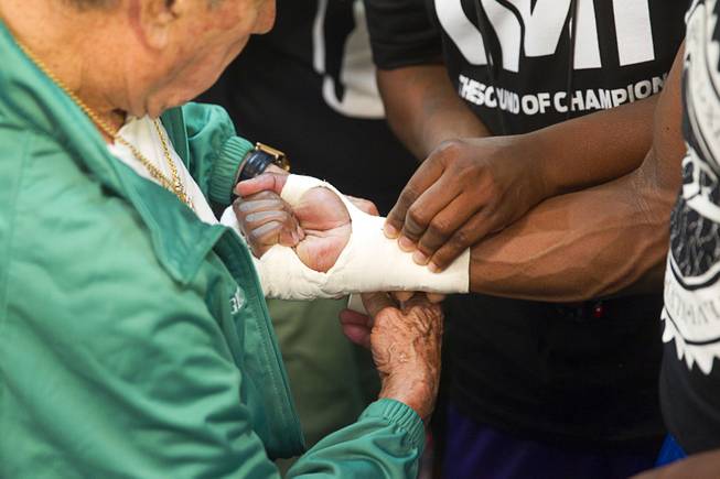 Cutman Rafael Garcia, left, wraps Floyd Mayweather Jr.'s hands during a media day at the Mayweather Boxing Club Tuesday, Sept. 2, 2014. Mayweather will face Marcos Maidana of Argentina in a rematch at the MGM Grand Garden Arena on Saturday, Sept. 13.