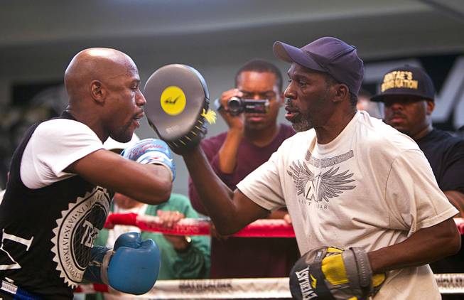 WBC/WBA welterweight champion Floyd Mayweather Jr., left, works on his timing with uncle and trainer Roger May weather during a media day at the Mayweather Boxing Club Tuesday, Sept. 2, 2014. Mayweather will face Marcos Maidana of Argentina in a rematch at the MGM Grand Garden Arena on Saturday, Sept. 13.