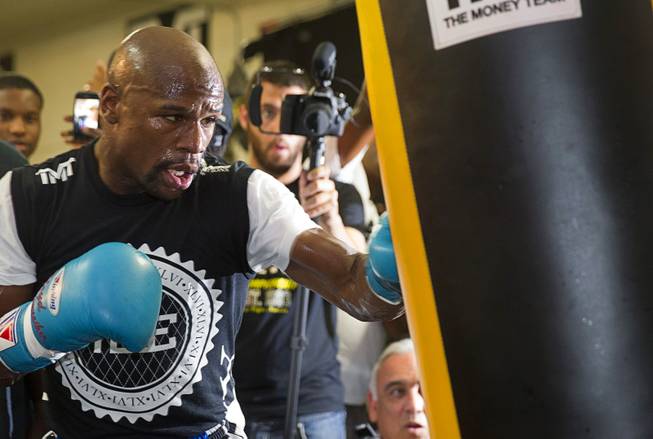 WBC/WBA welterweight champion Floyd Mayweather Jr. hits a heavy bag during a media day at the Mayweather Boxing Club Tuesday, Sept. 2, 2014. Mayweather will face Marcos Maidana of Argentina in a rematch at the MGM Grand Garden Arena on Saturday, Sept. 13.