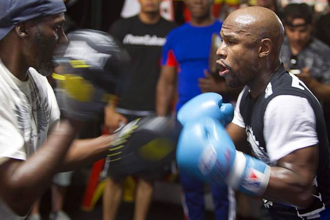 WBC/WBA welterweight champion Floyd Mayweather Jr., right, works on his timing with uncle and trainer Roger May weather during a media day at the Mayweather Boxing Club Tuesday, Sept. 2, 2014. Mayweather will face Marcos Maidana of Argentina in a rematch at the MGM Grand Garden Arena on Saturday, Sept. 13.